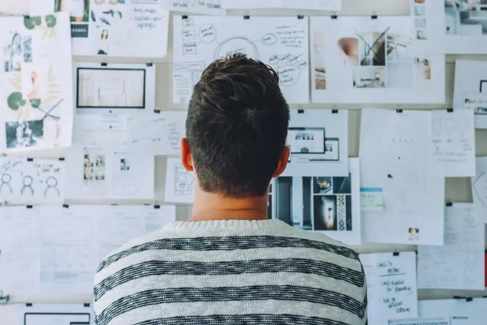 Man looking at his workflow management wall