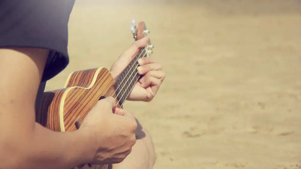 man practicing guitar