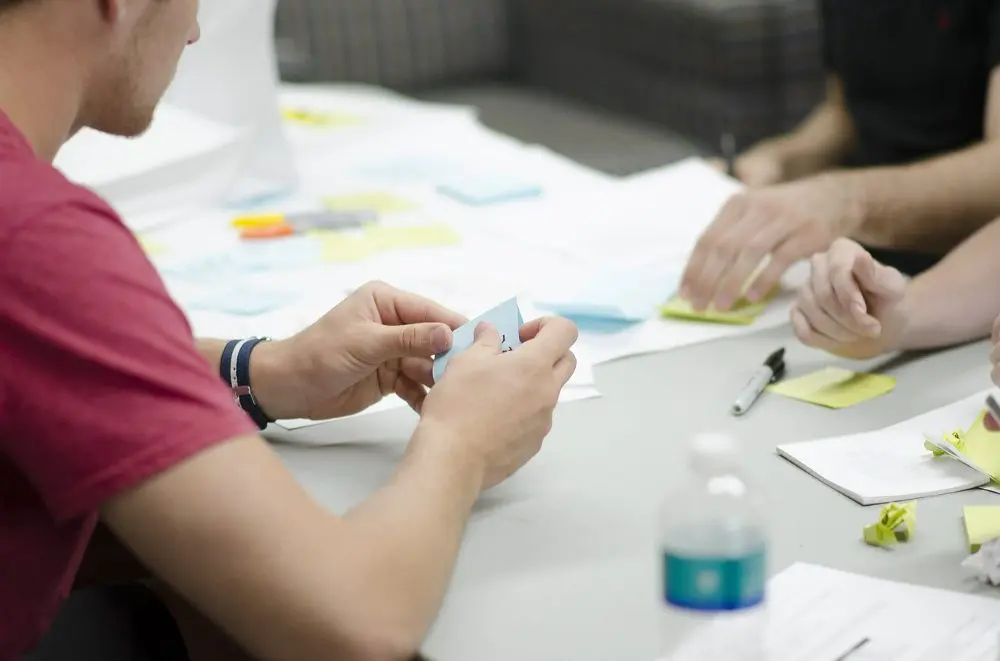 Team using sticky notes while brainstorming methods