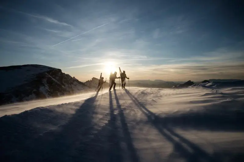 Three people hiking on snow in search of the Agile Manifesto