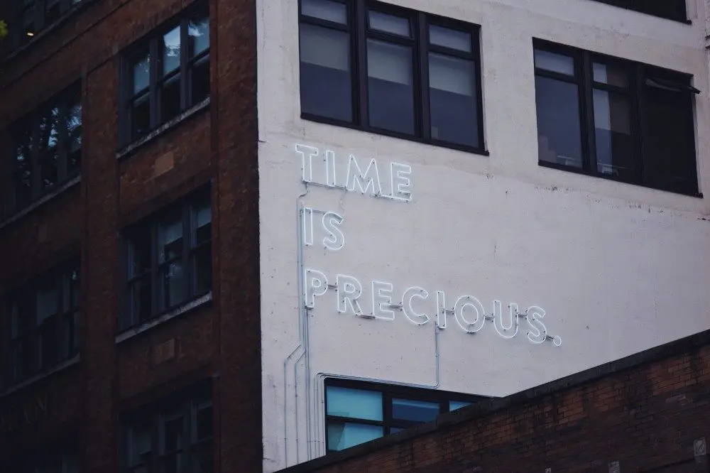 time is precious neon sign on a building