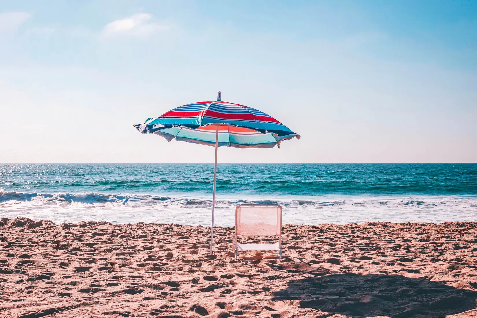 Umbrella and sun chair on the beach