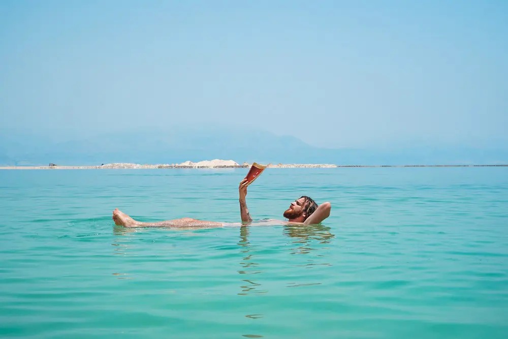 Man reading while floating in water