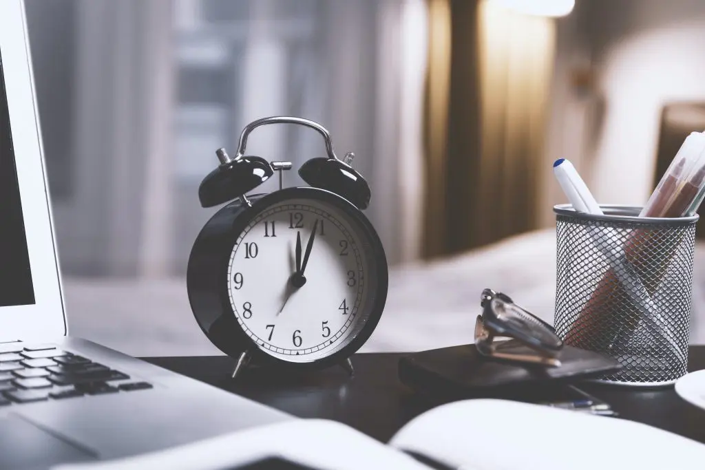 black alarm clock on desk