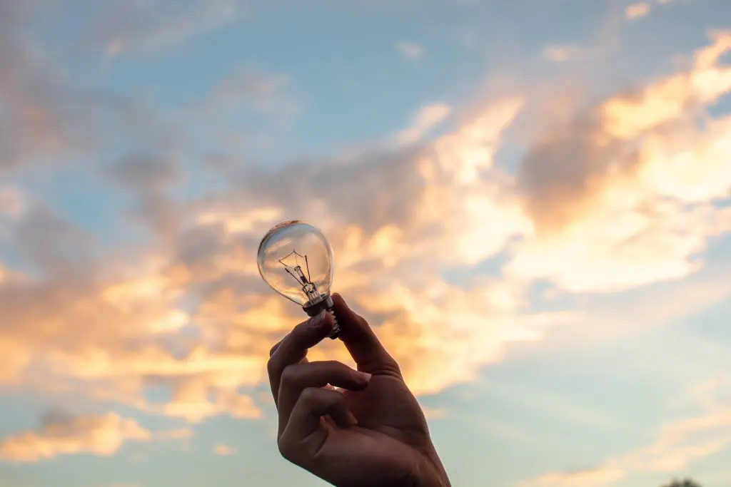 hand holding light up sky background