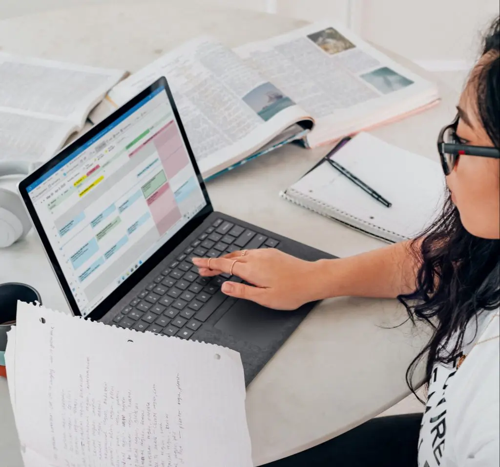 female studying taking notes checking calendar